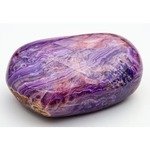 Charoite gemstone showcases intricate purple patterns and a polished surface. the stone features unique swirls and colors, emphasizing its natural beauty. ideal for jewelry design, geology studies, and artistic inspiration.